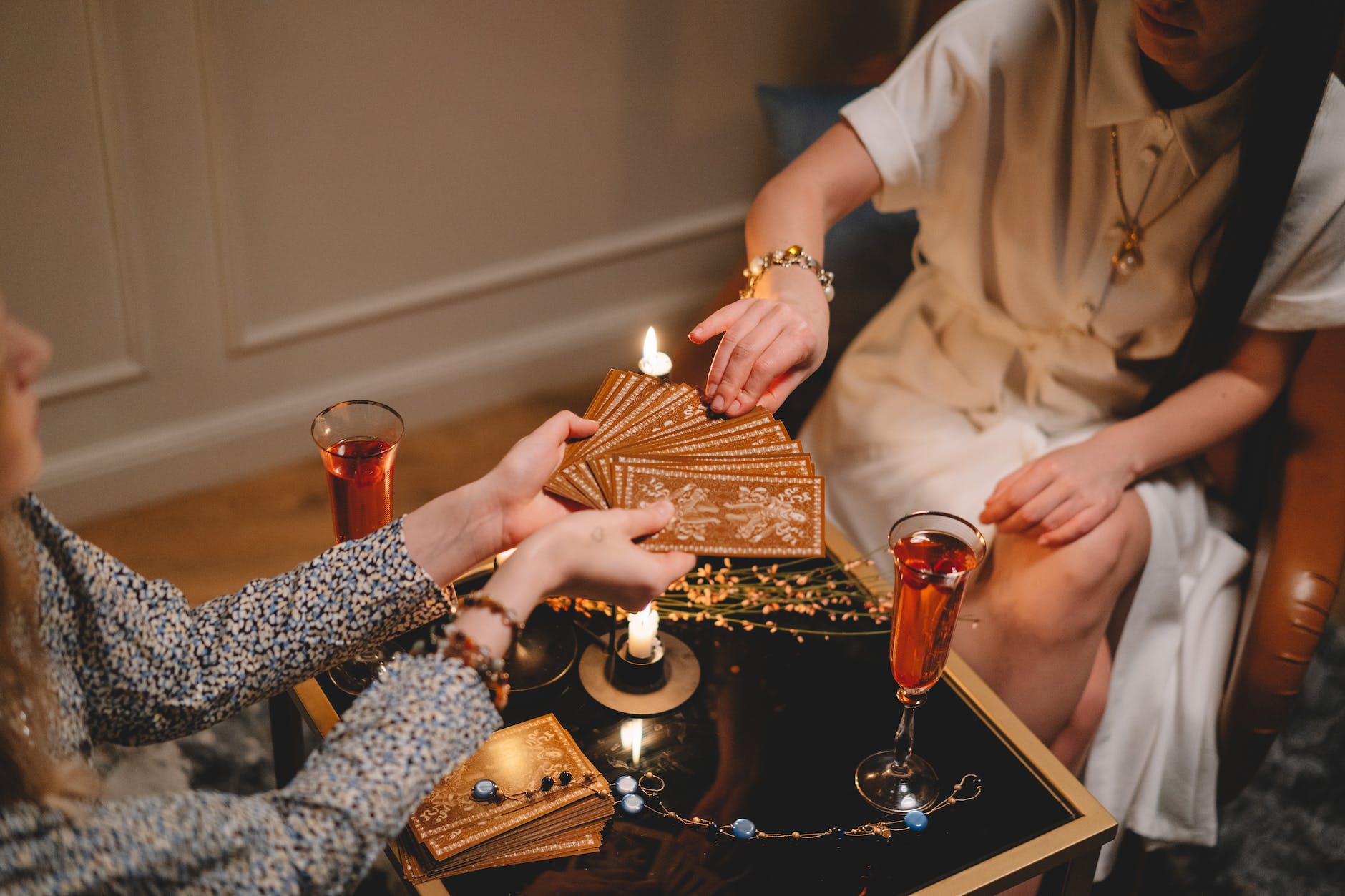 woman in white dress choosing tarot cards