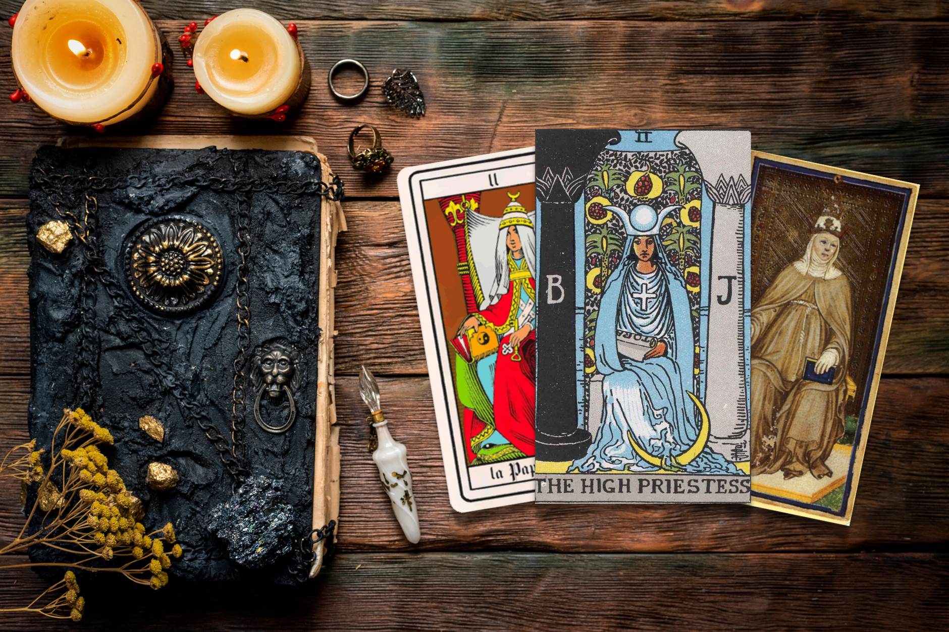 Three tarot cards on a desk